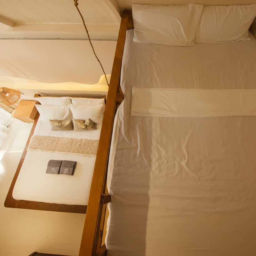 The full-sized loft bed above, the queen bed made up below