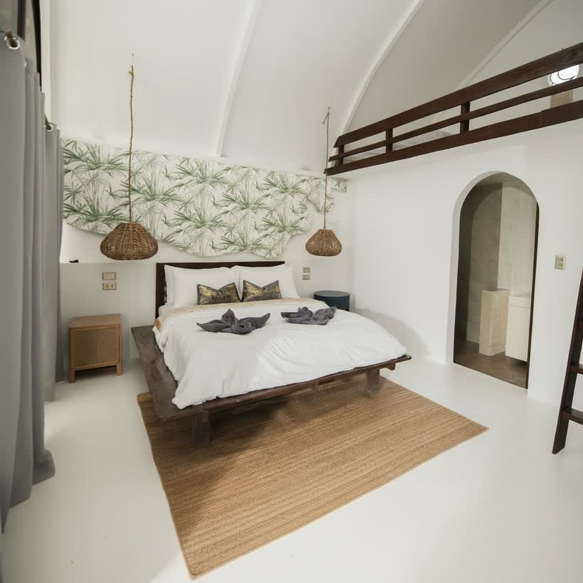 Queen bed under the high arched ceiling of the Beach Bungalow Family