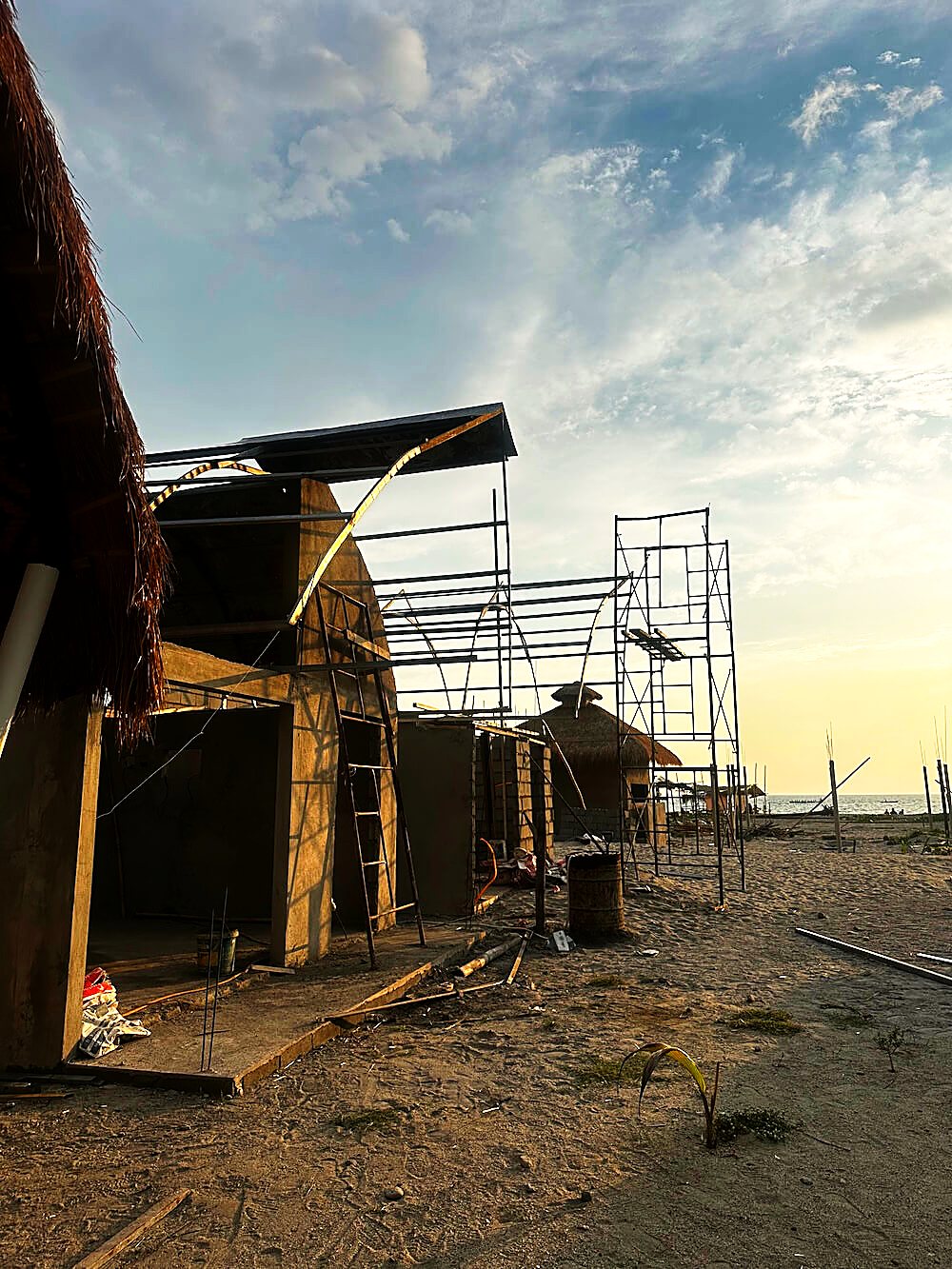 Bungalows under construction, thatch roofs taking shape