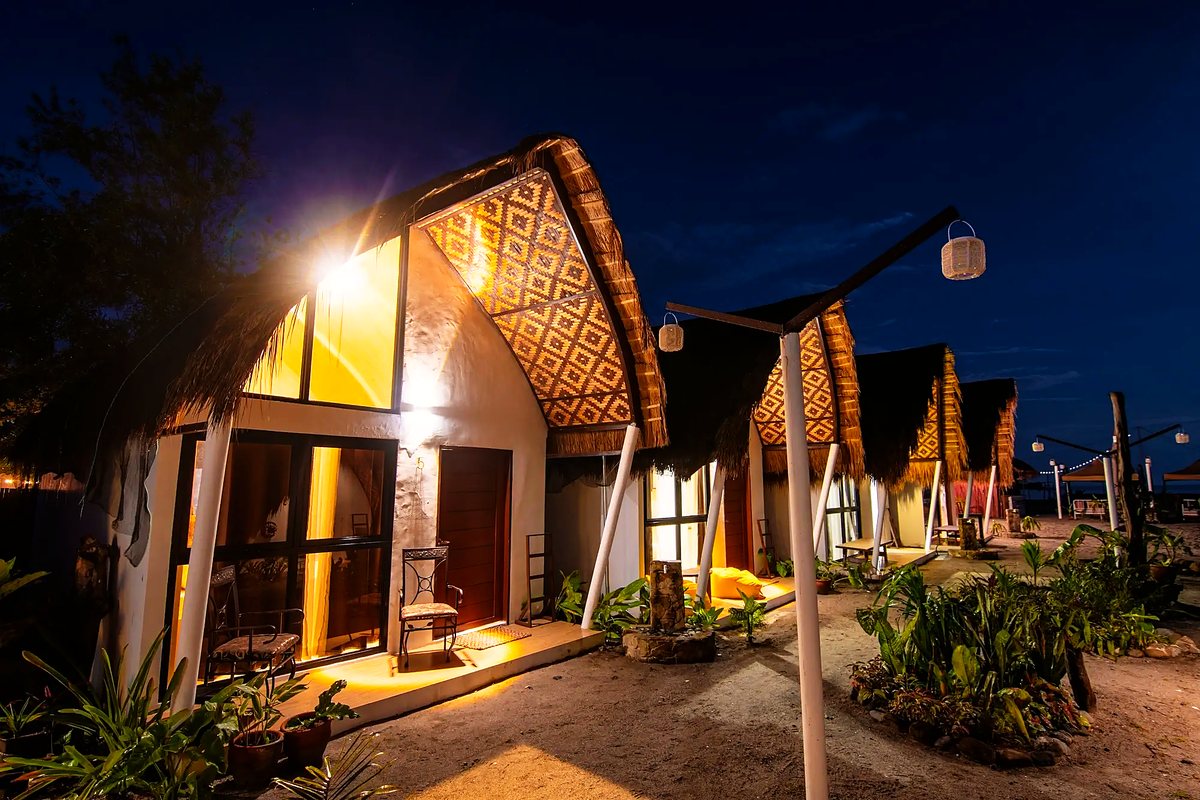 The finished bungalows lit warmly after dark